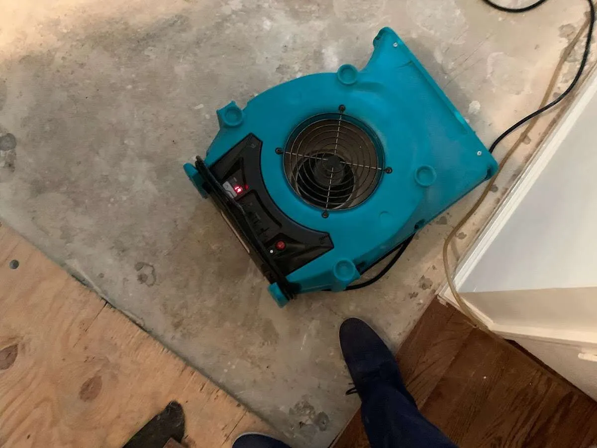 Air mover drying subfloor during Leak Detection & Repair in Blanchard